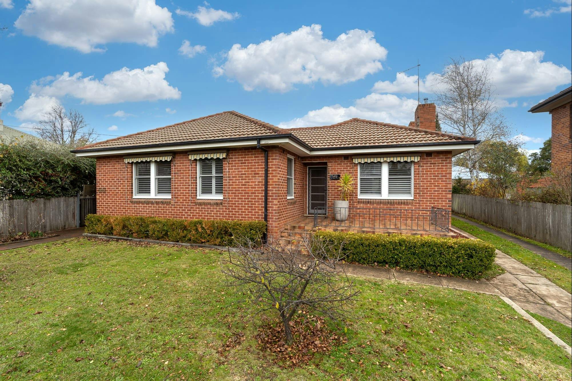 Red brick home of a solid home in Orange NSW with a large verandah.