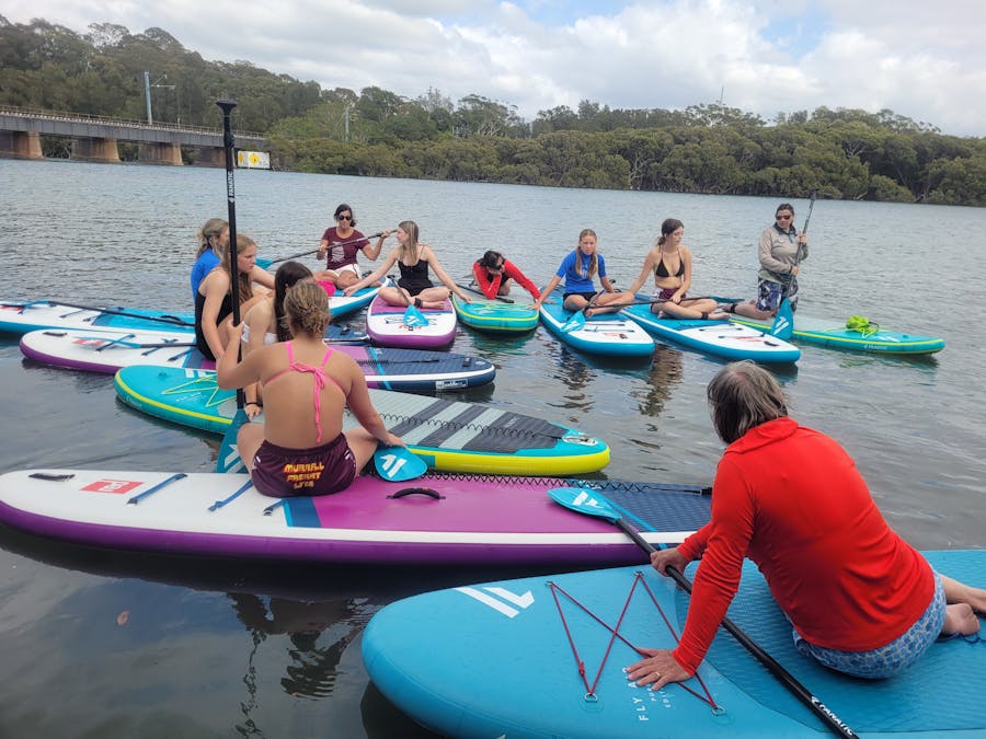 A group of paddlers listening to cultural stories on Minnamurra River