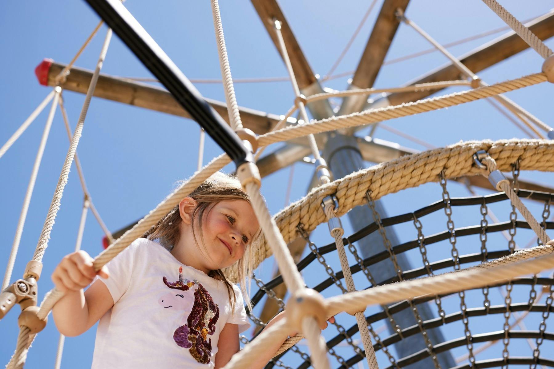 Child climbing on a play frame, richardson park playspace at Sevenhill