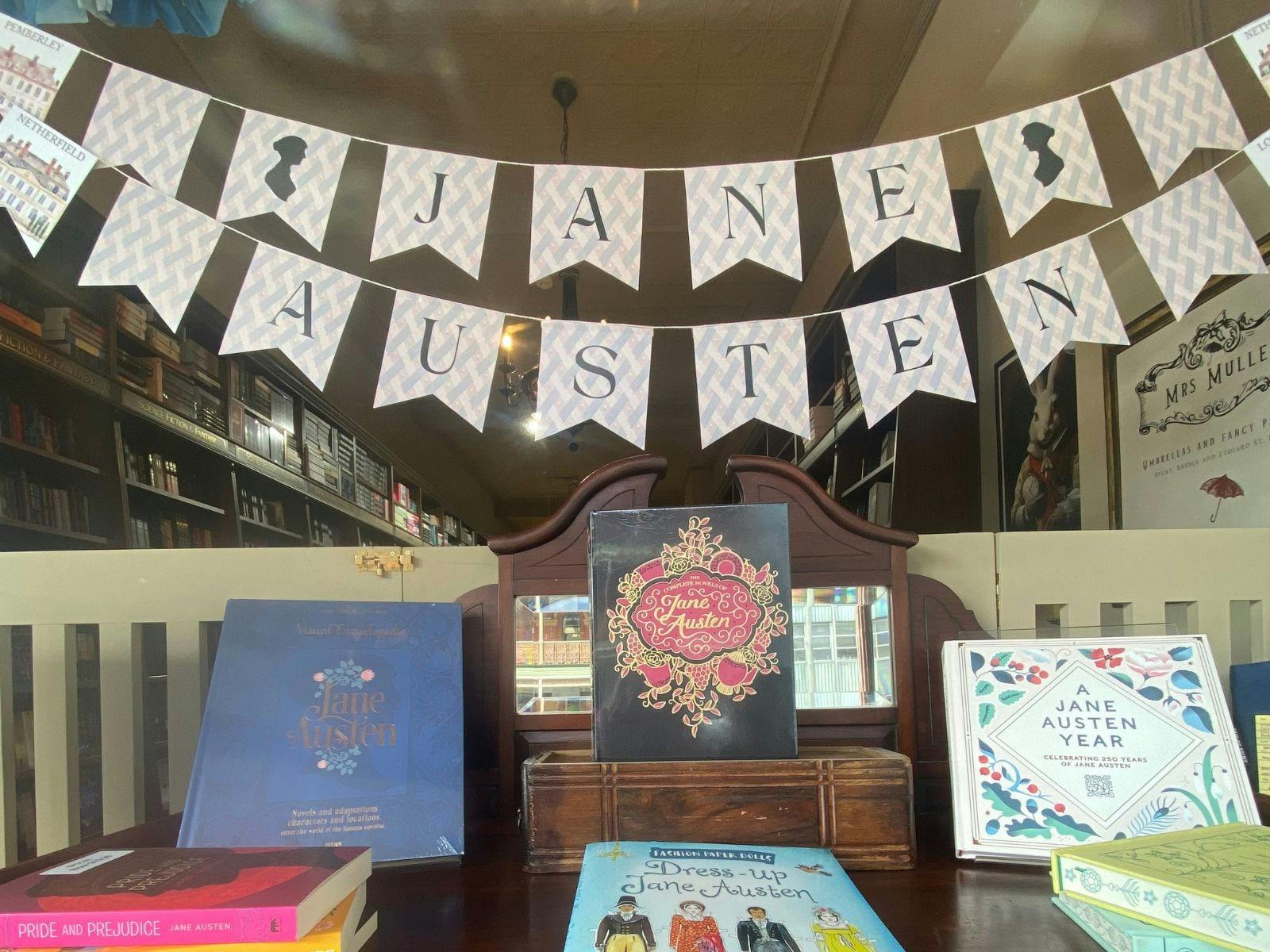 A window display featuring bunting that says Jane Austewn