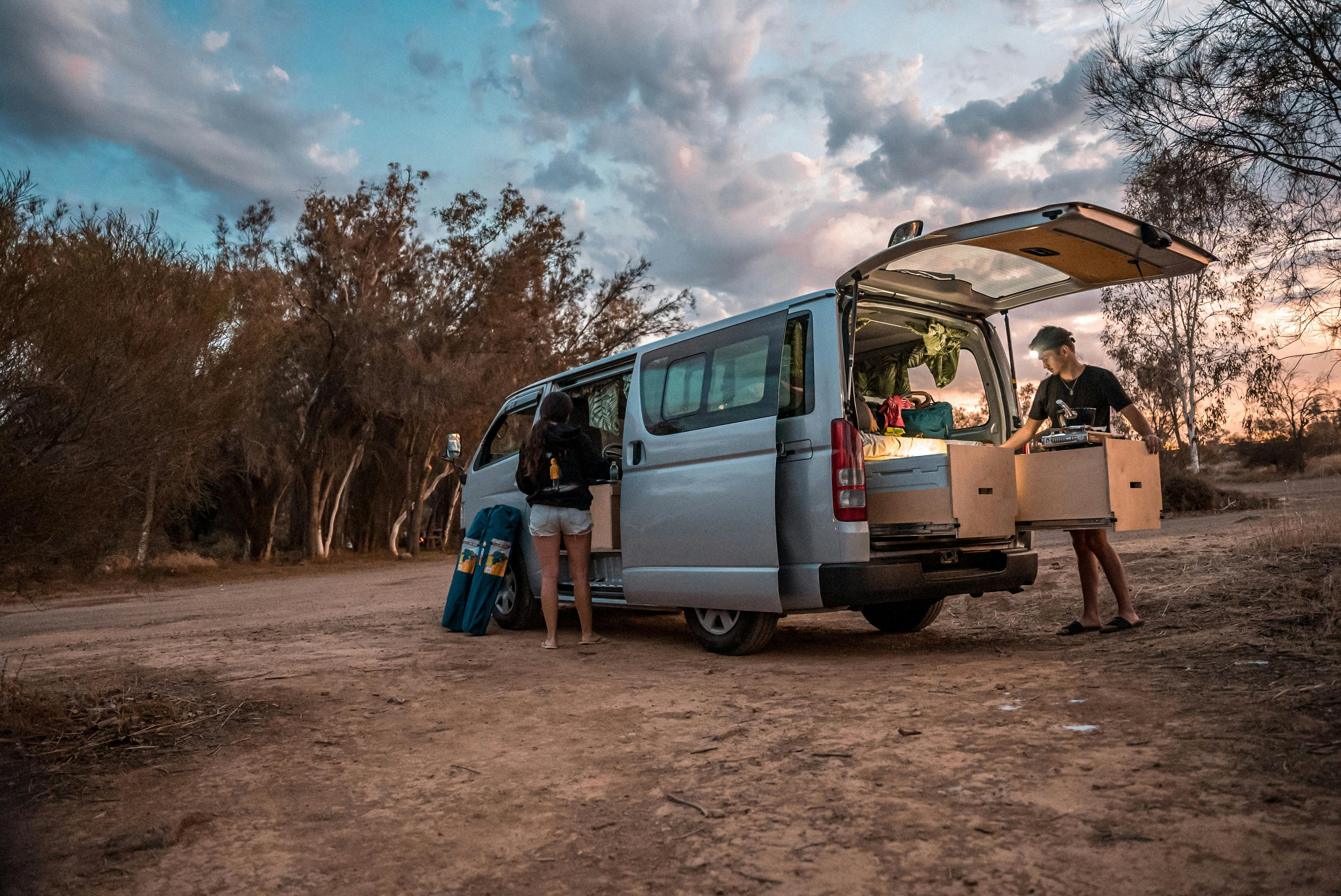 Man opening campervan kitchen