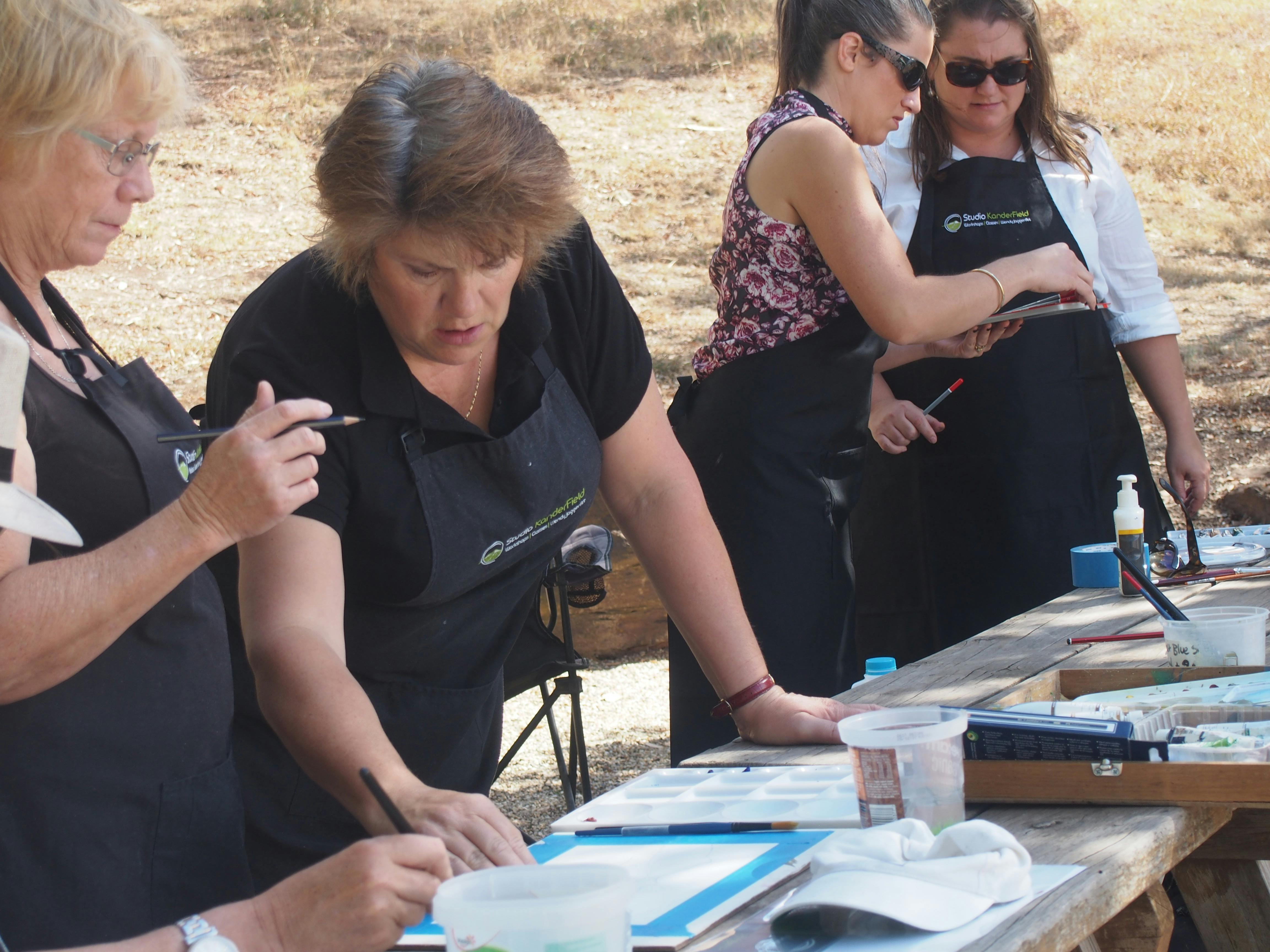 Artist Wendy Jagger instructing students during a painting workshop.