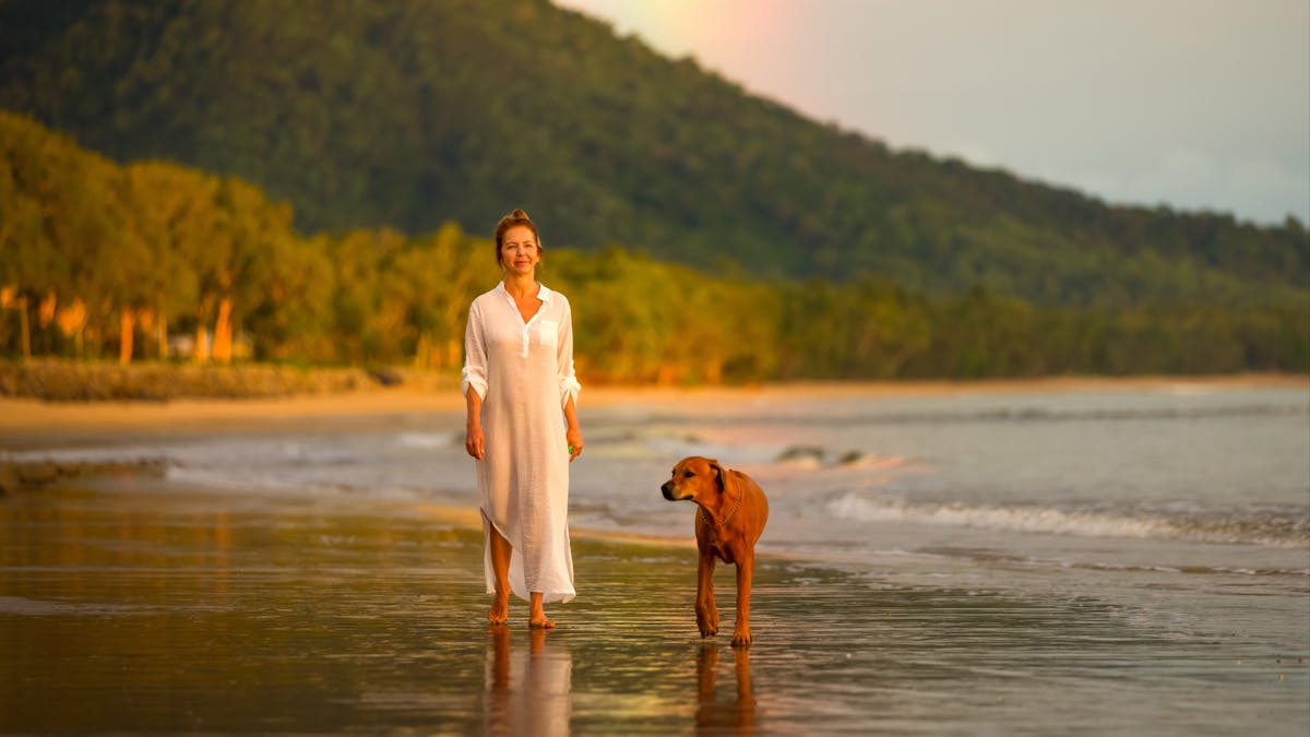 Professional holiday photography session at Kewarra Beach, QLD with shoreline reflections, tropical