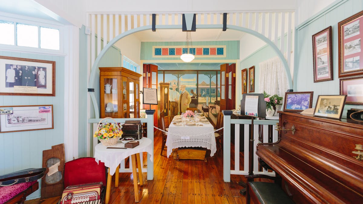 view into living room with piano and period furntiure
