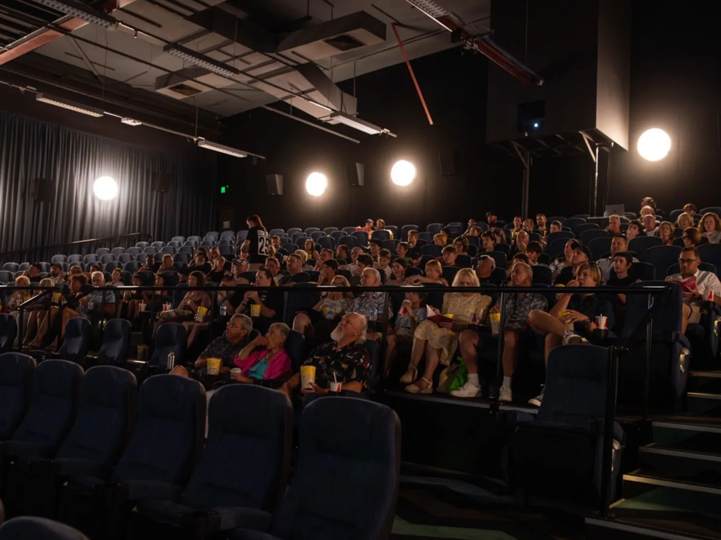 People in a movie theater waiting for the films to start