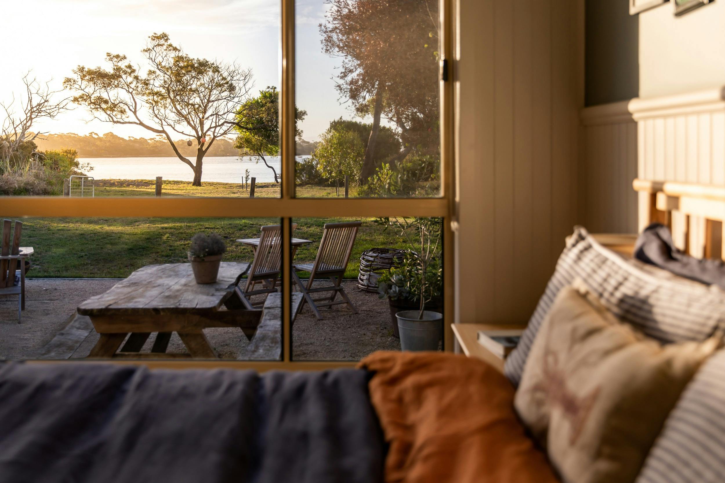 A view of the ocean from the inside of a beachside shack bedroom
