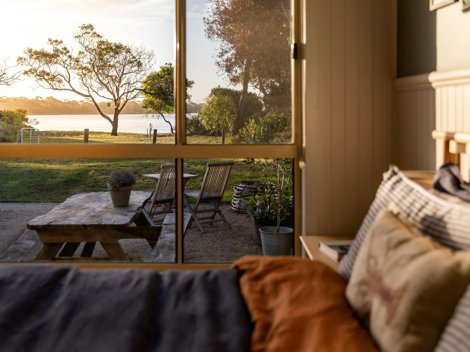 A view of the ocean from the inside of a beachside shack bedroom
