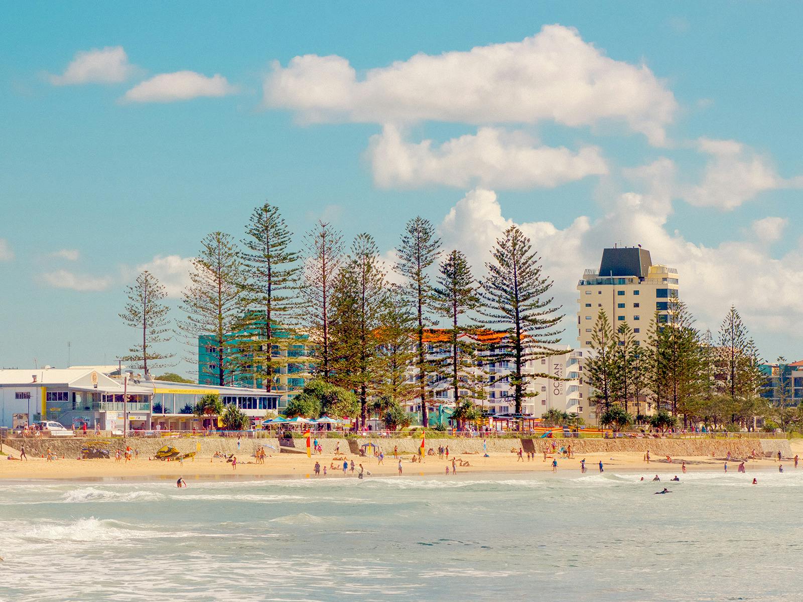 Looking west at Alexandra Headland surfclub and pine trees.