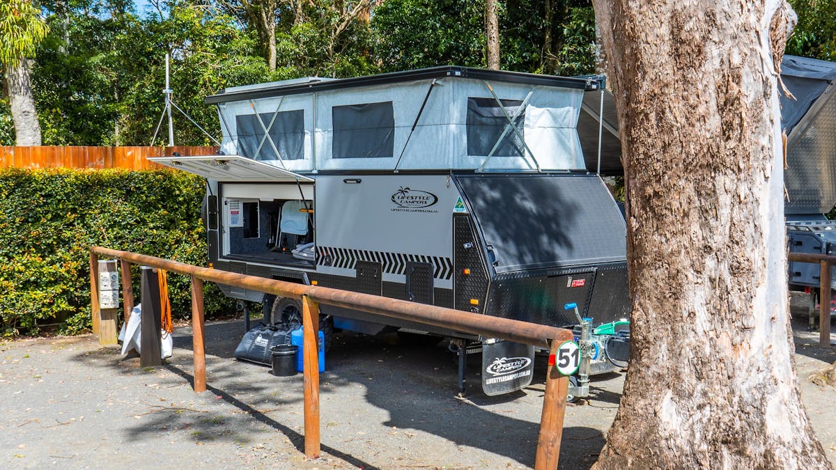 Image shows a caravan set up at the campsite