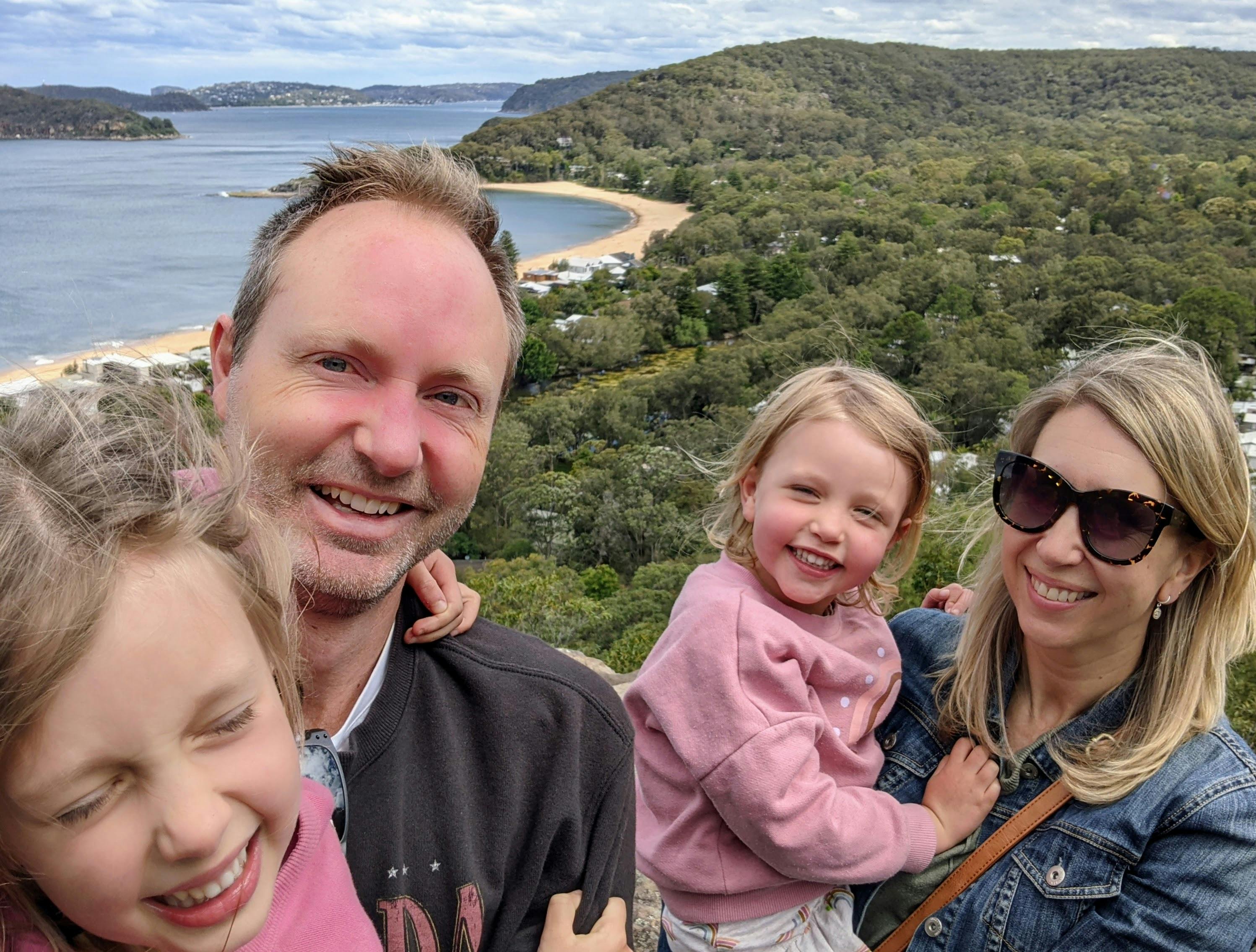 Ben Barry, owner of Personalised Sydney Tours with guests at Mt Ettalong with views of Pearl Beach