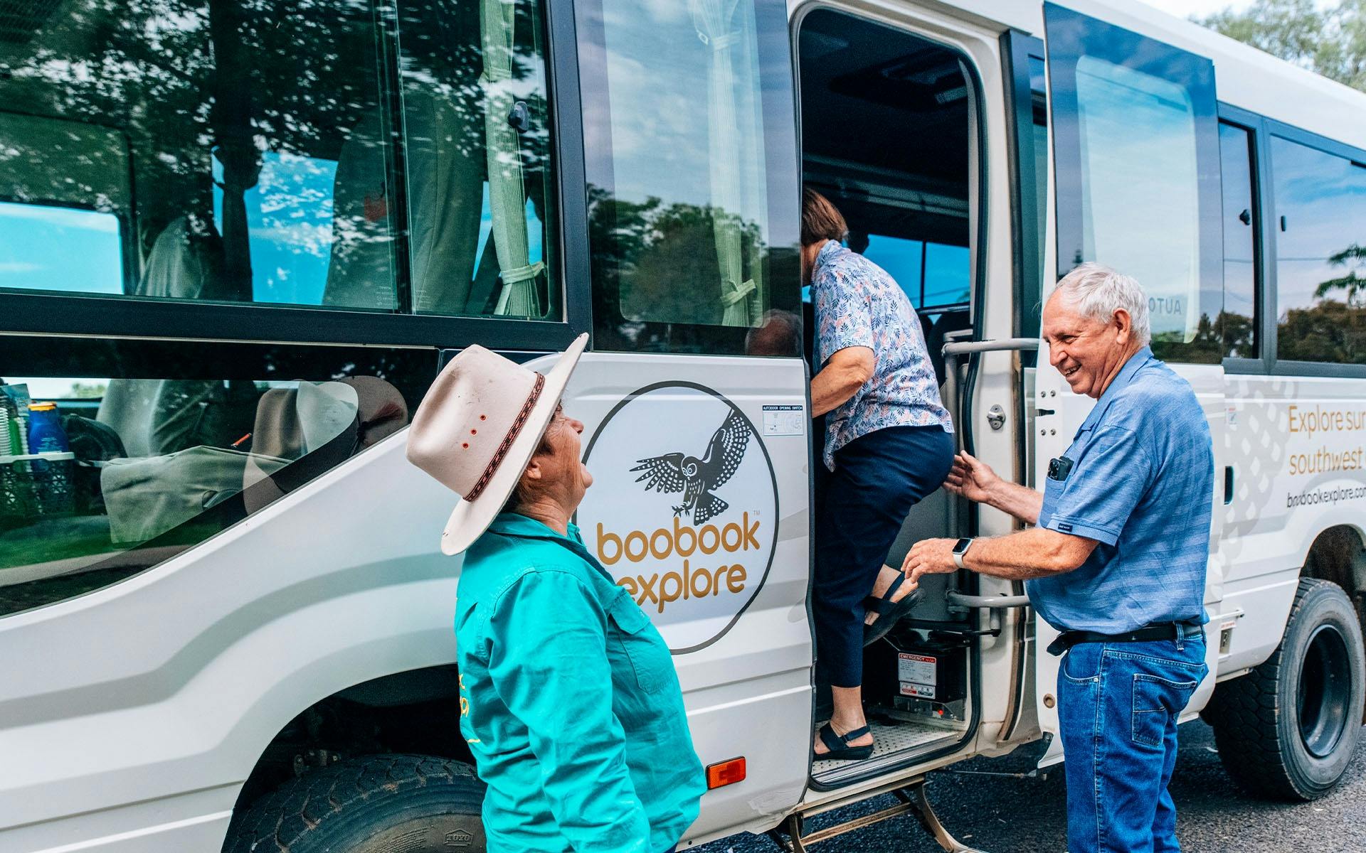 Meryl Eddie laughing with guests boarding the bus