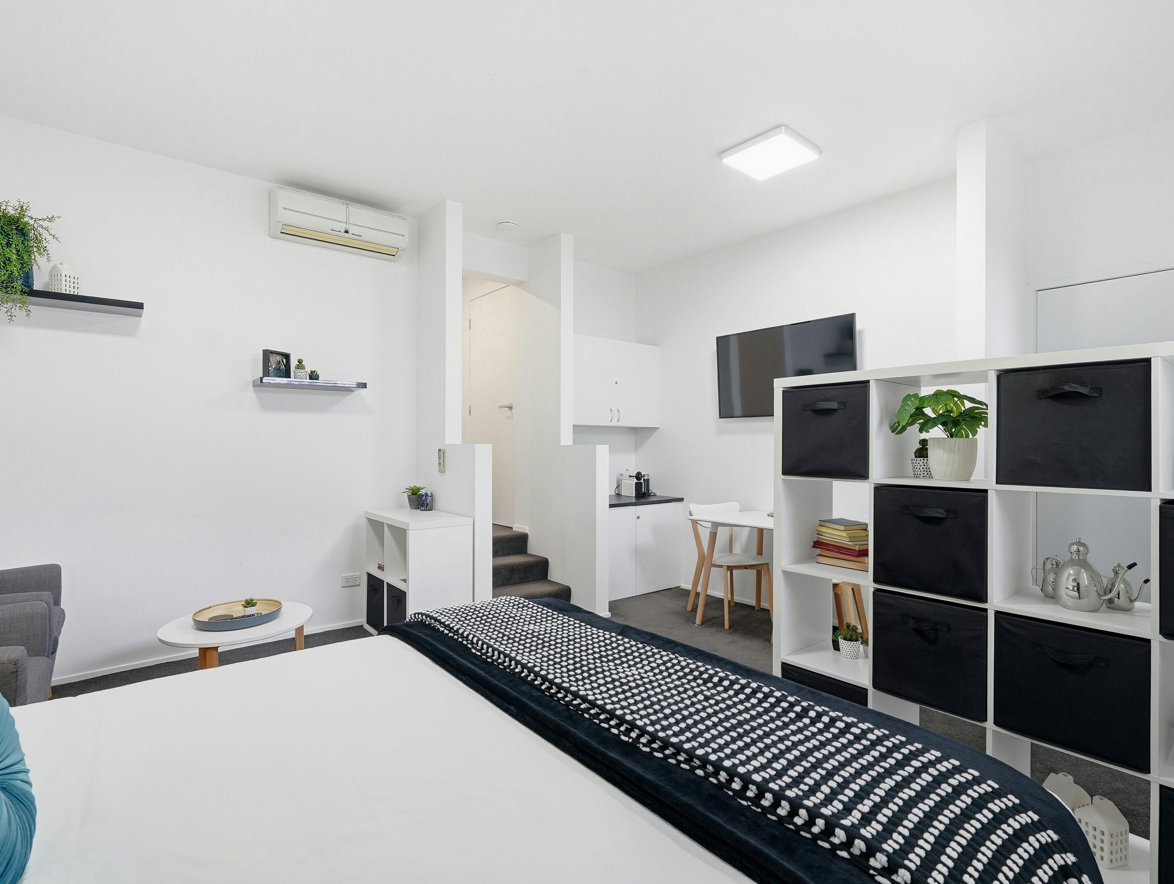 Queen bed within the open-plan studio with quality linen