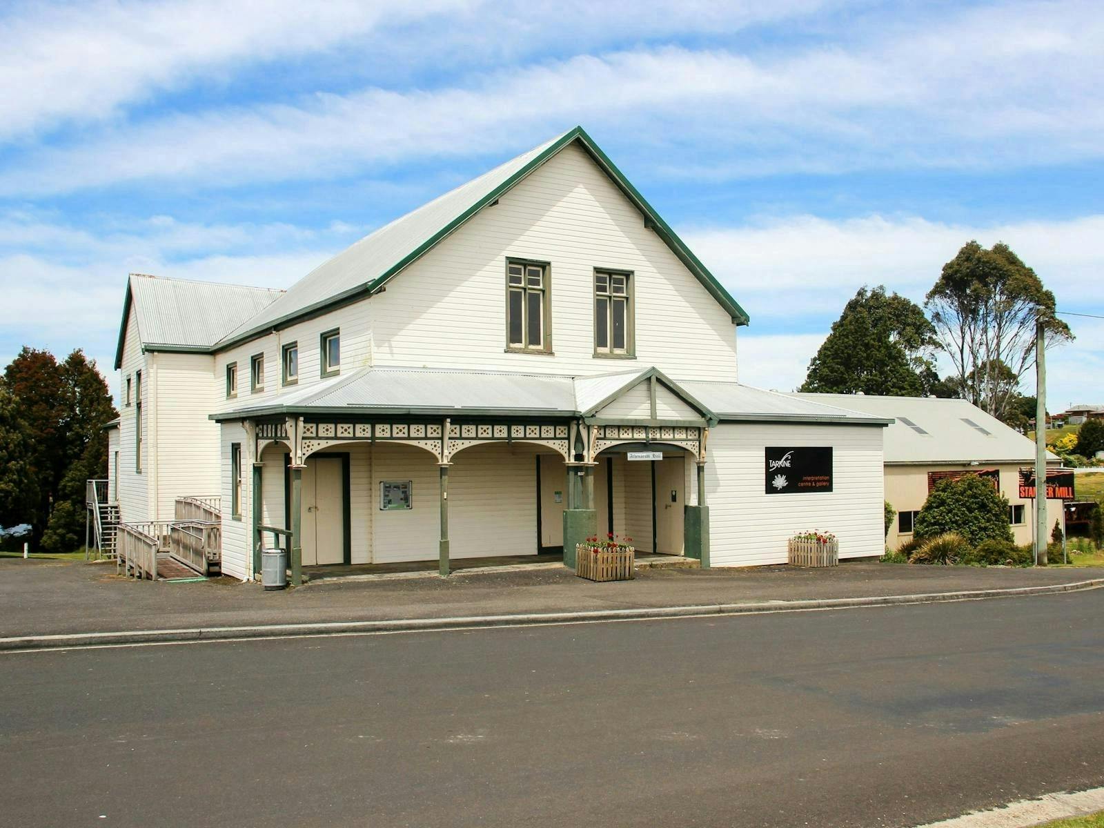 Historic white timber Athenaeum Hall building in Waratah, Tasmania, viewed from the street.