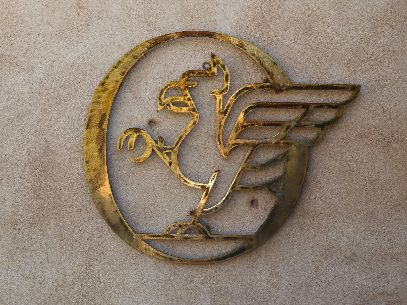 Golden Griffin logo on wall