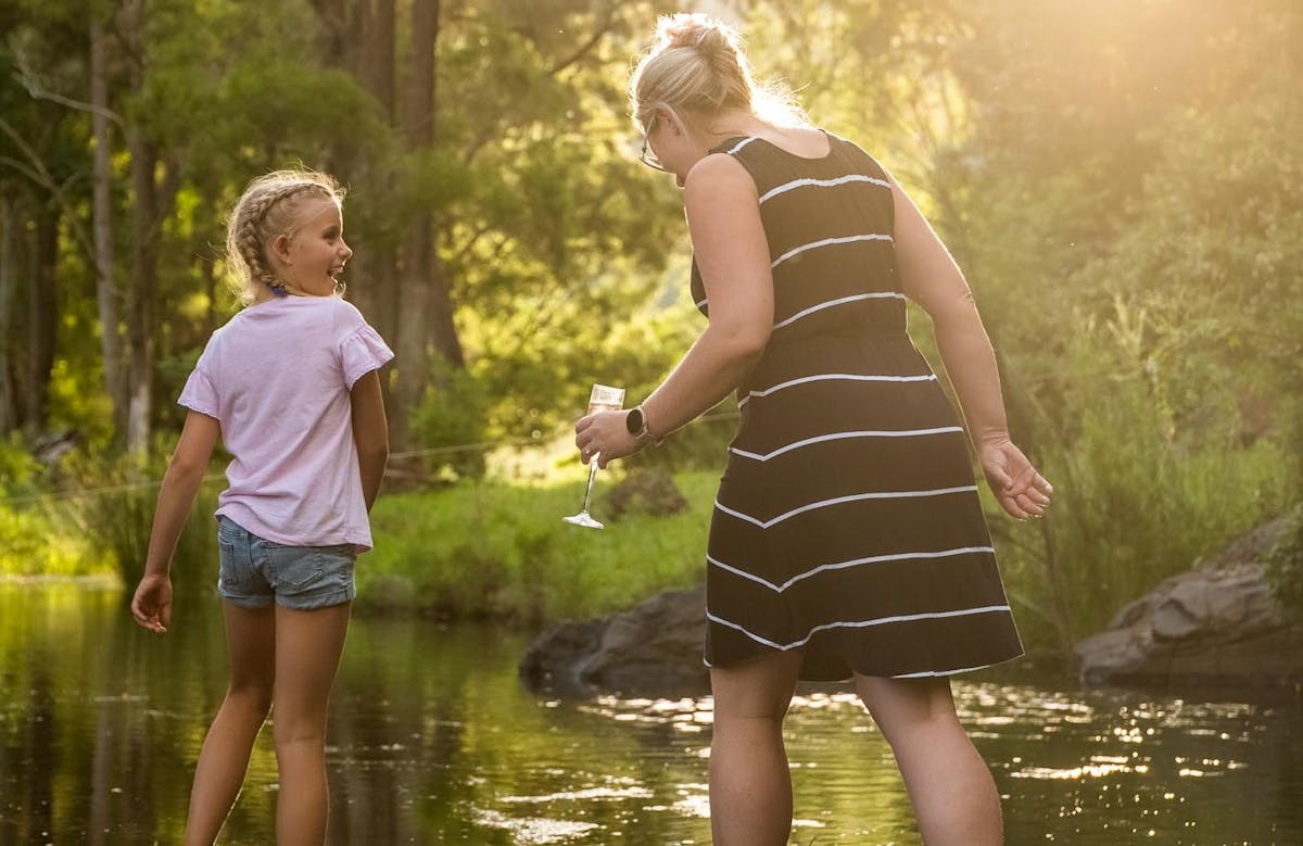 Afternoon light with a woman and young girl paddling down Stockyard Creek.