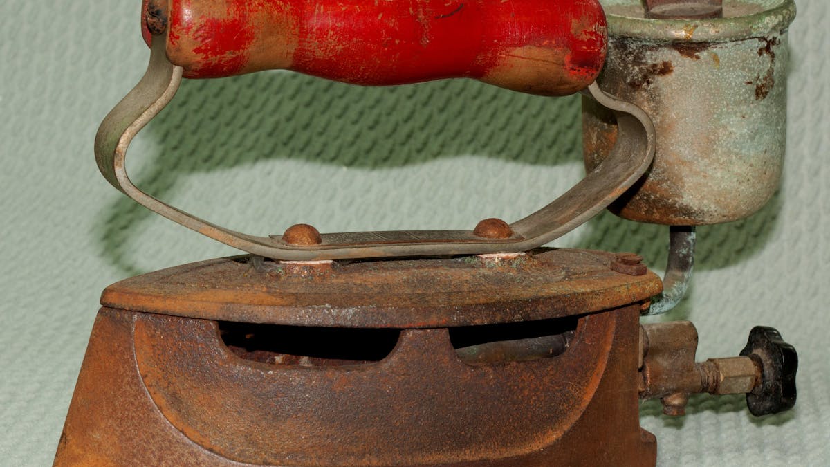 An iron which heated its base by burning a fuel, usually white spirit.