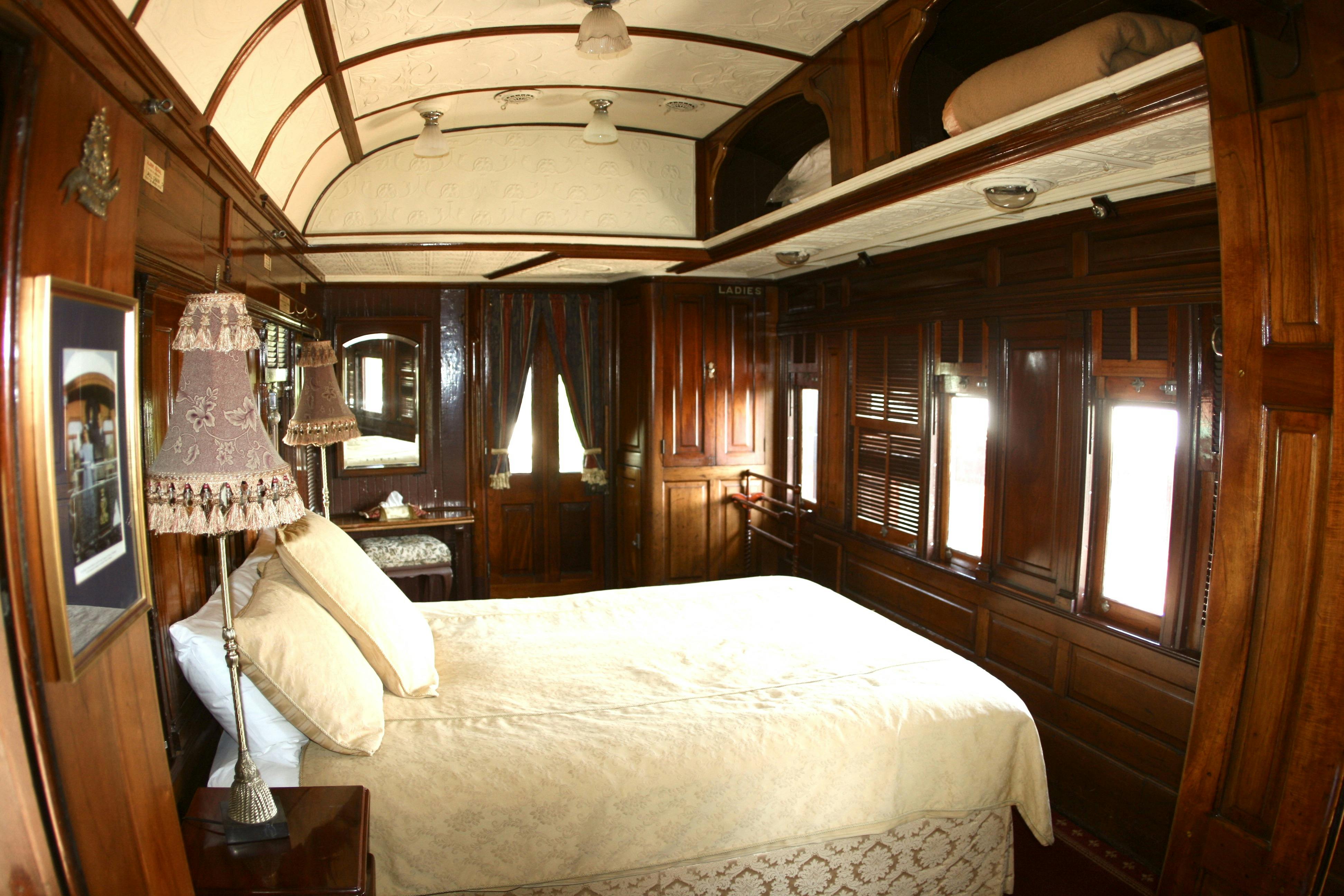 A view of the bedroom inside the State Car at Ruwenzori Rail Retreat