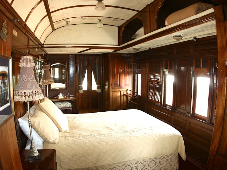 A view of the bedroom inside the State Car at Ruwenzori Rail Retreat