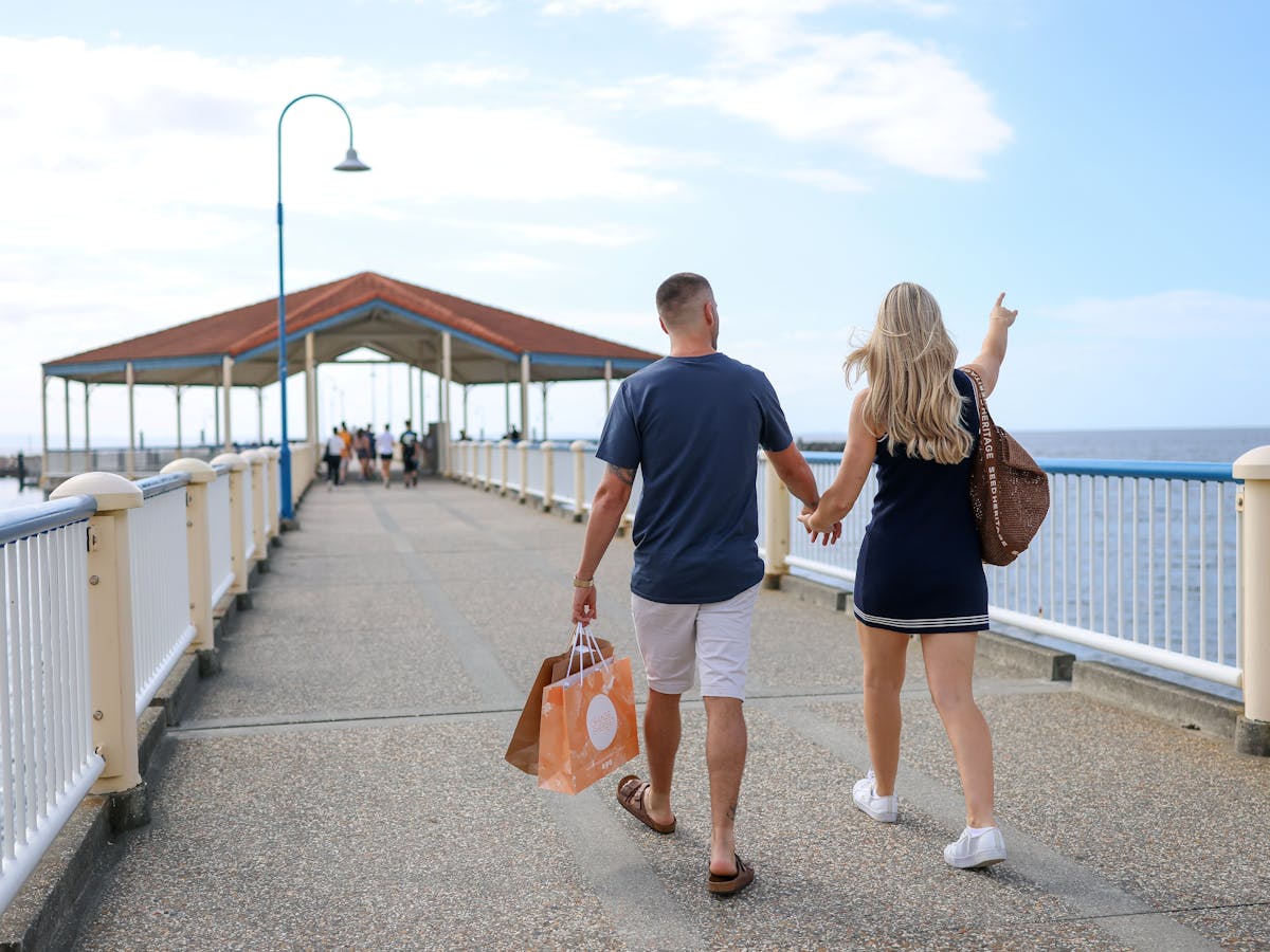Couple walking along Redcliffe Jetty