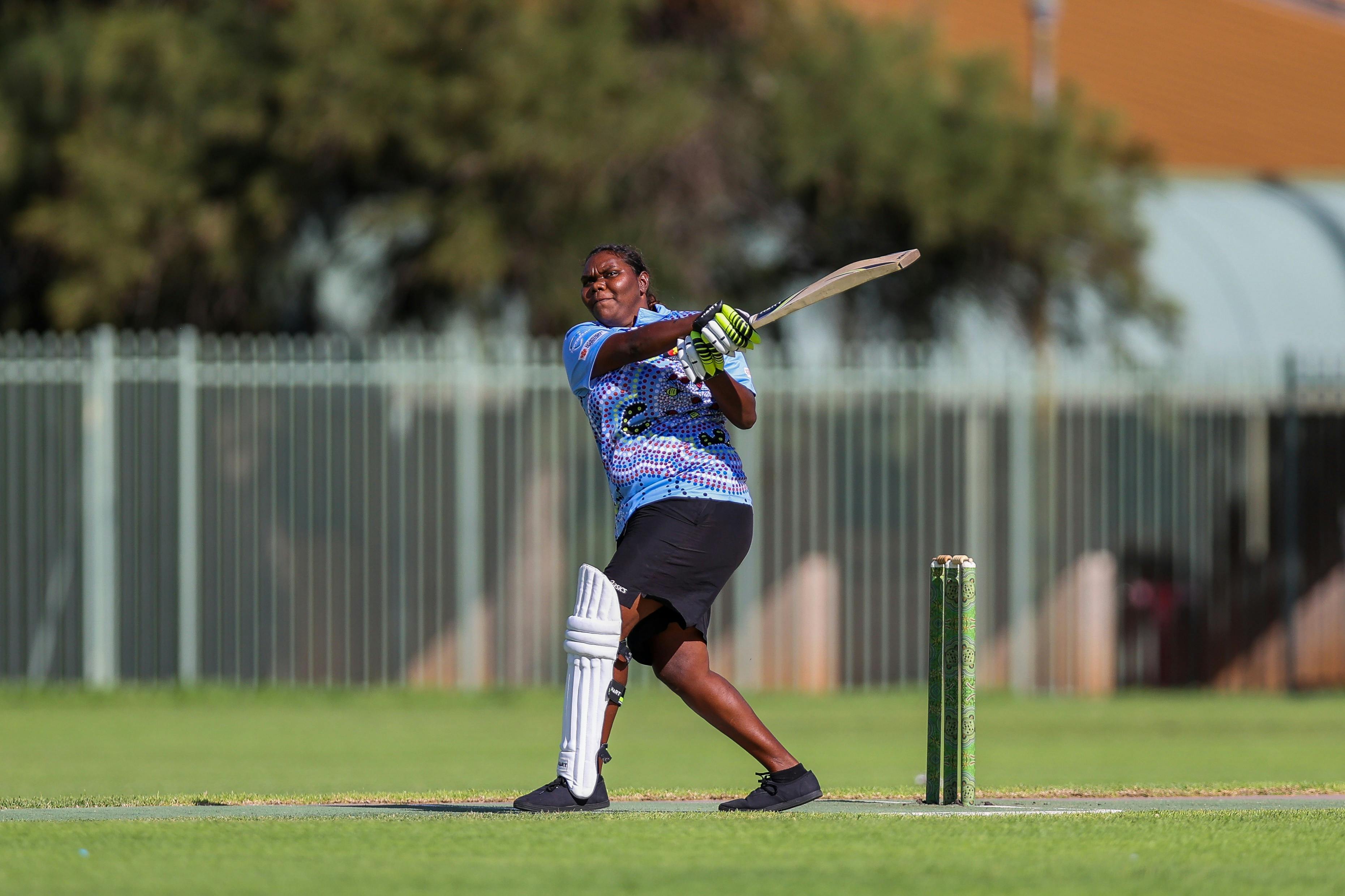 Indigenous women batting in cricket game