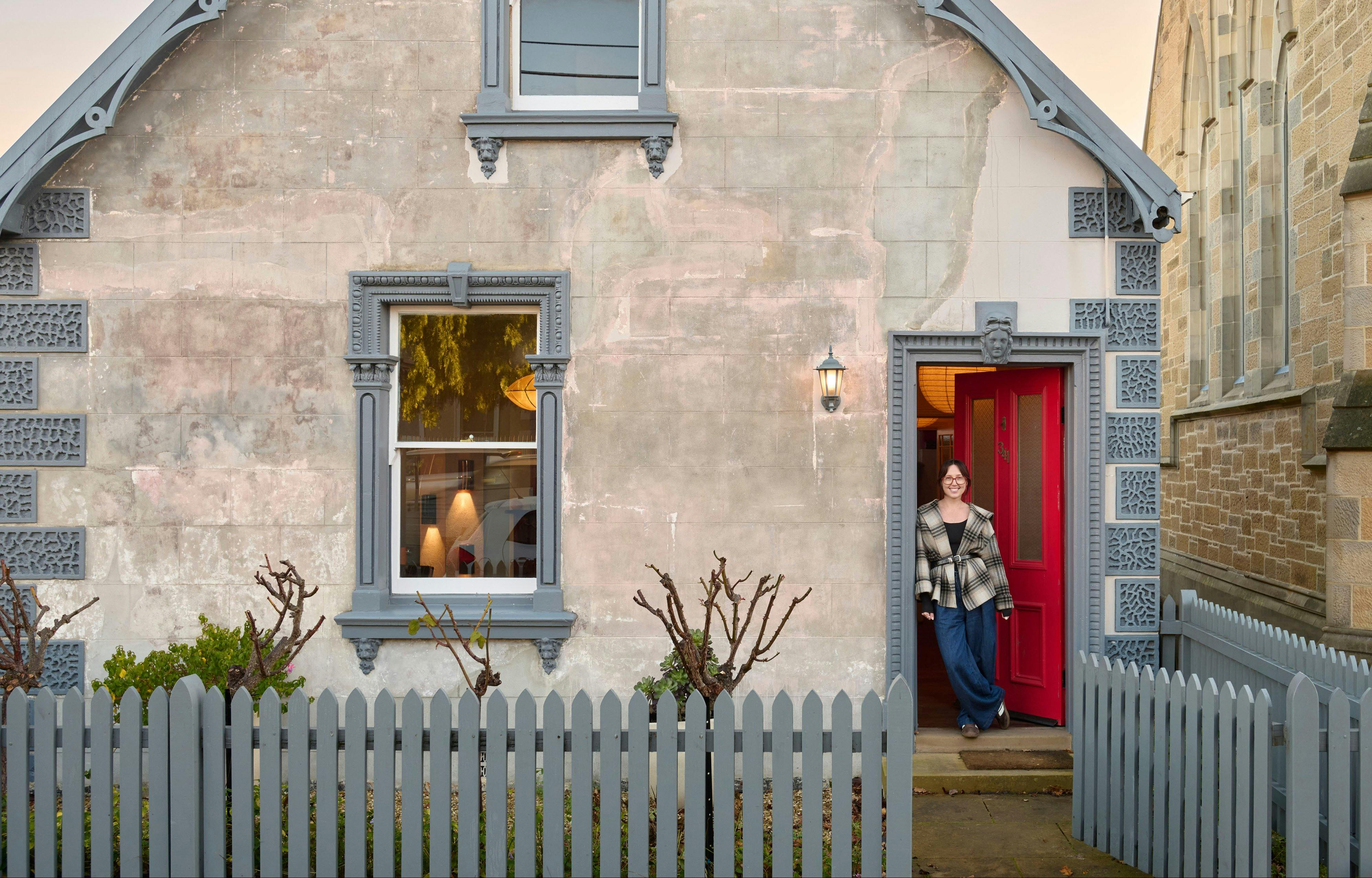 Rose Kiselev at the red doorway of We Ponder's stone studio in South Hobart.