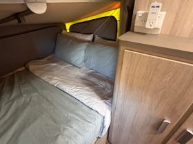 A double bed made with pale green bedding