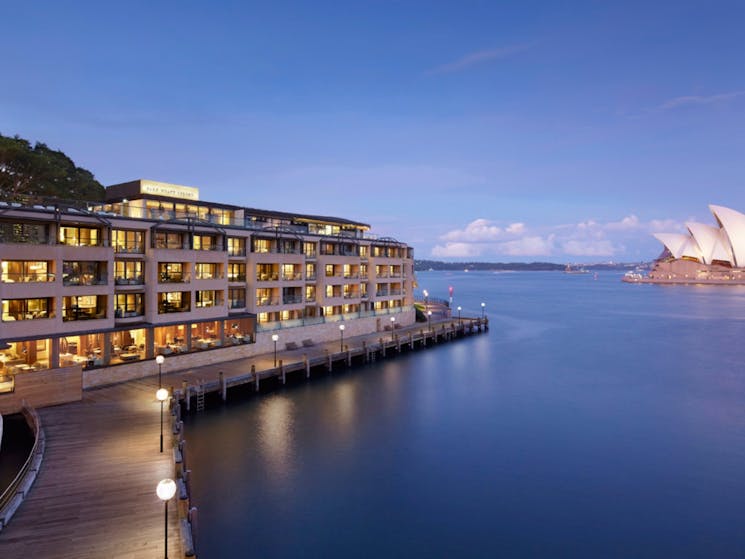 Hero landscape shot of Park Hyatt Sydney hotel under Harbour Bridge and across from the Opera House