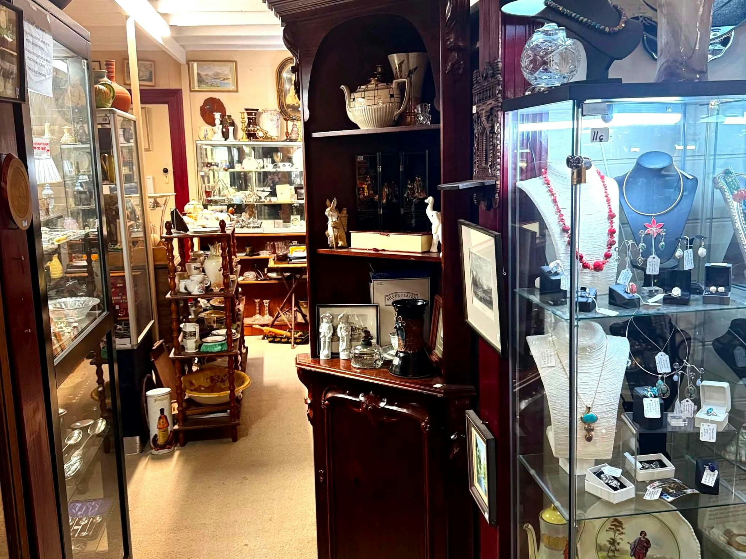 Glass display cabinets with antique jewellery, silver, and collectables
