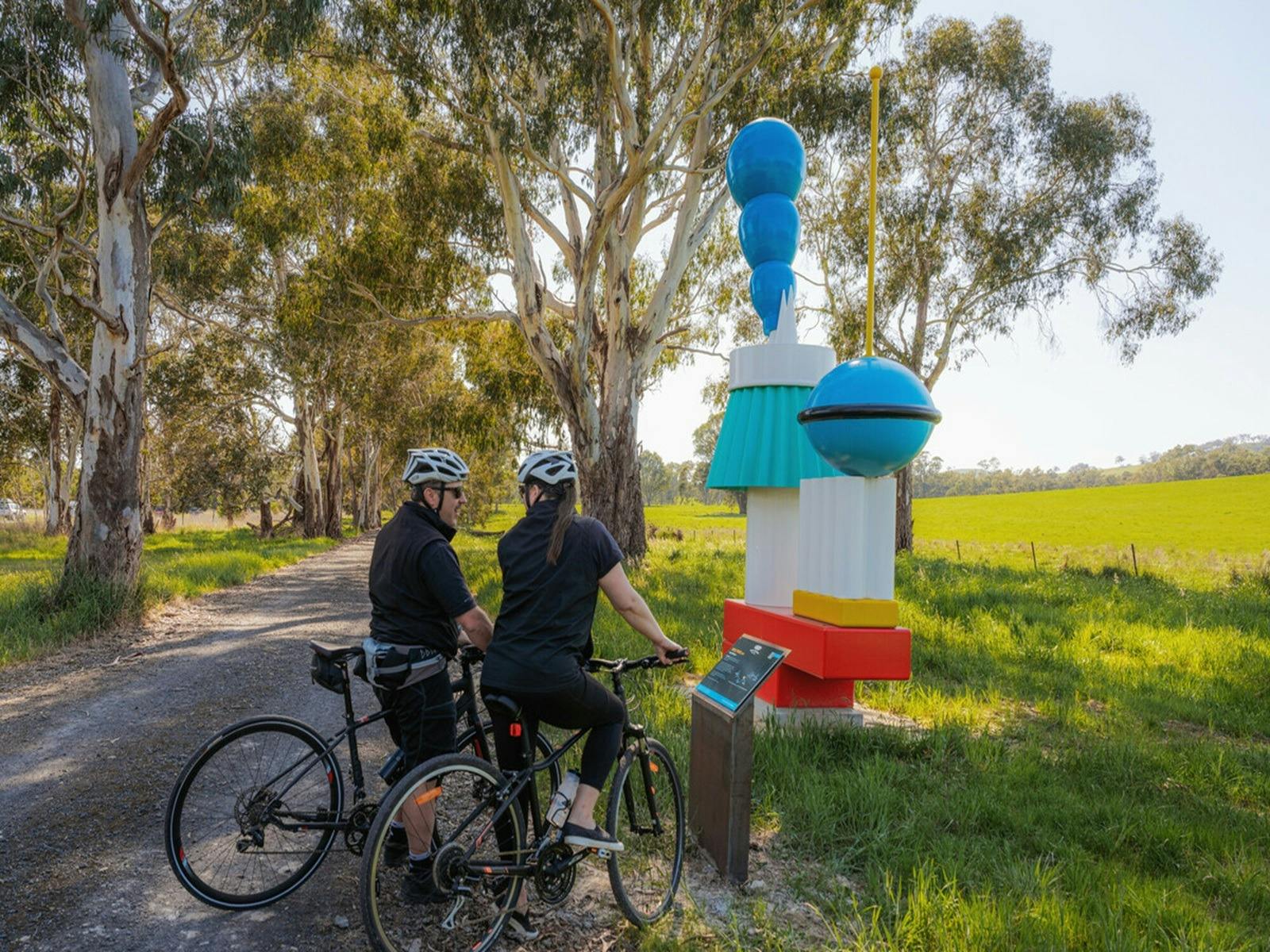 Guests stop to look at artwork that features on a bike ride