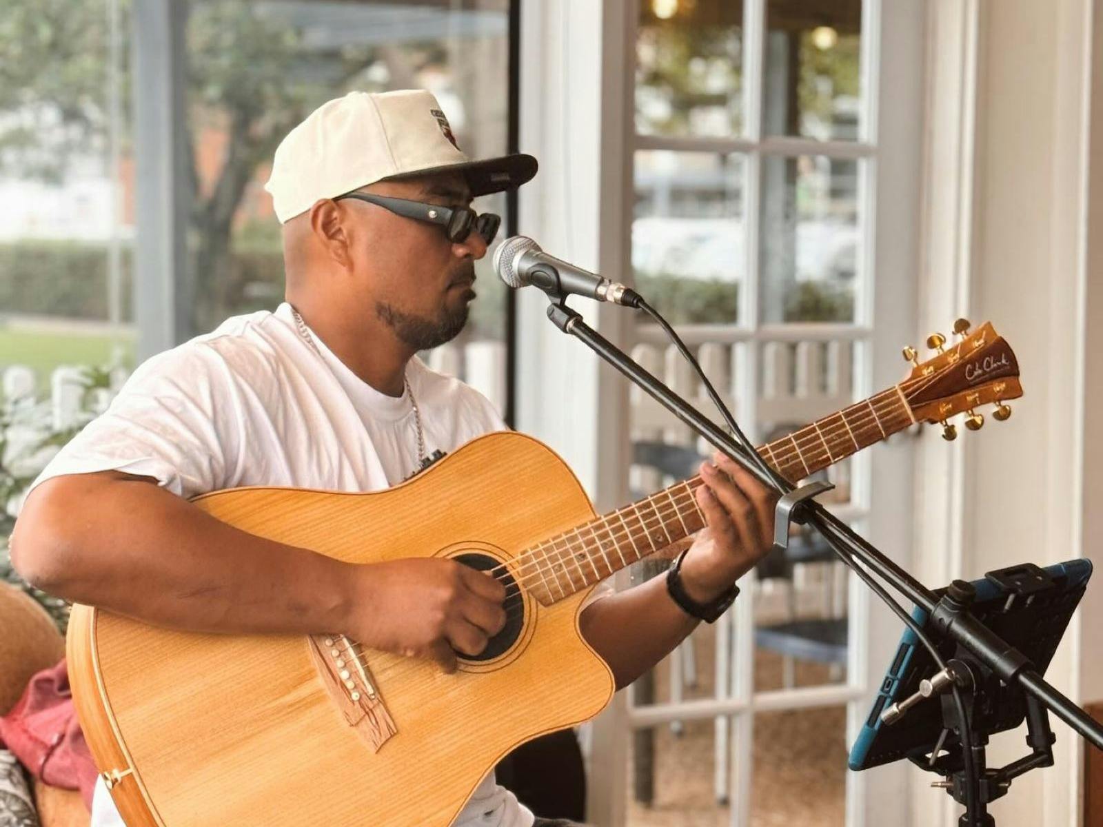 man playing acoustic guitar and singing