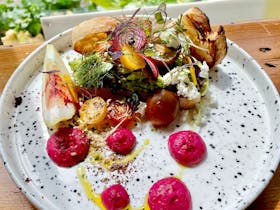 Breakfast plate with smashed avocado,  beetroot hummus, tomato, whipped persian feta and dukkah