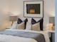 Hester arthouse townhouse bedroom with table side lamp and painting hanging on the wall