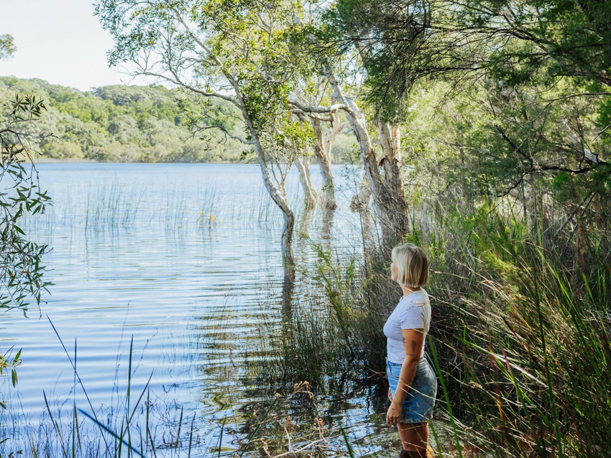 A lady standing in the water at Poona Lake