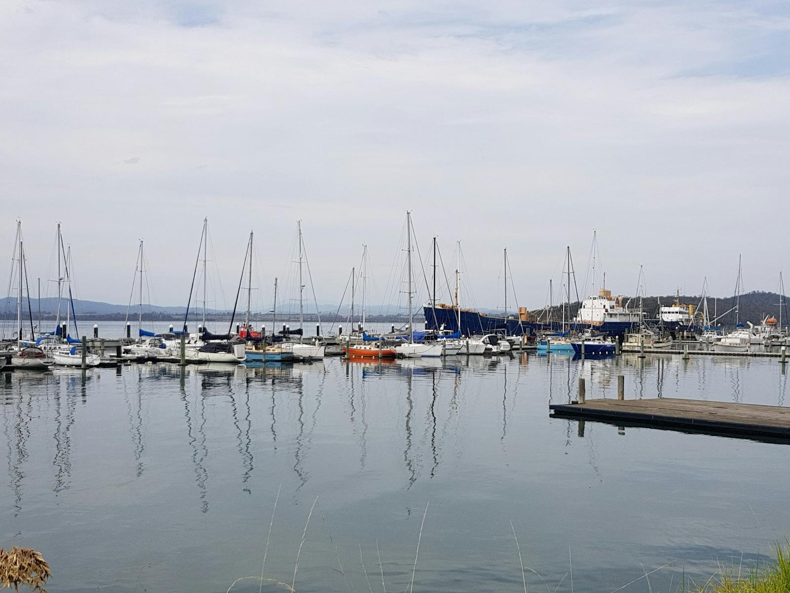 Boats on the still glassy water at Beauty Point Marina