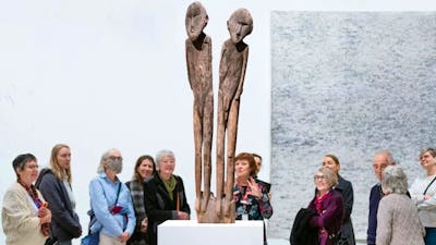 People gathered around a work of art