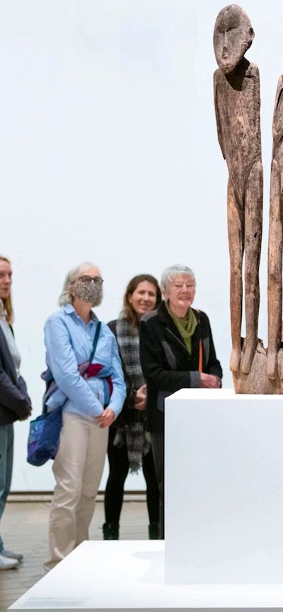 People gathered around a work of art