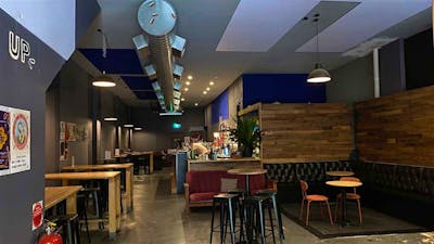 Image of Dissent Cafe & Bar's cozy and industrial style interior.