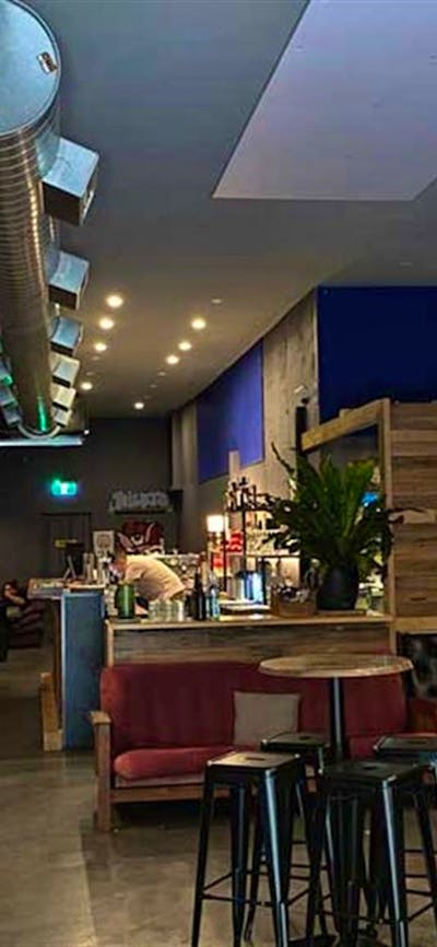 Image of Dissent Cafe & Bar's cozy and industrial style interior.
