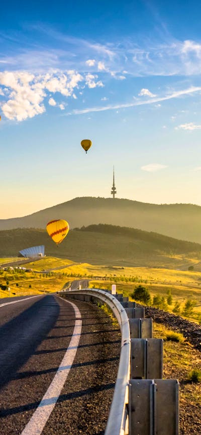 road framed by balloons on horizon