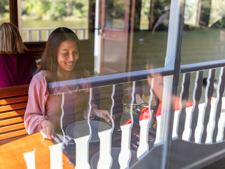 Couple enjoying food and drink aboard the Nepean Belle Paddlewheeler, Jamisontown