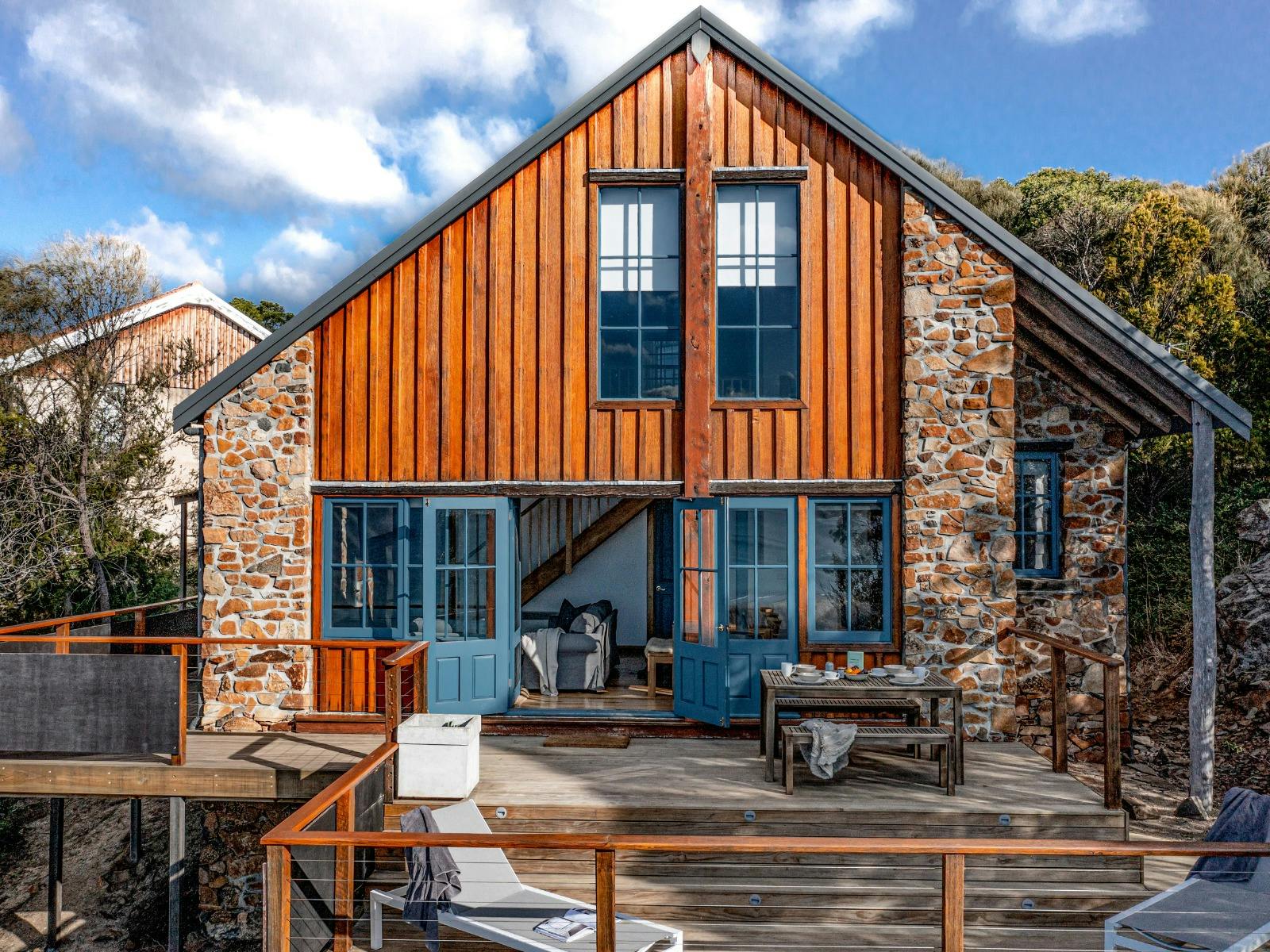 a stone cottage deck with blue doors