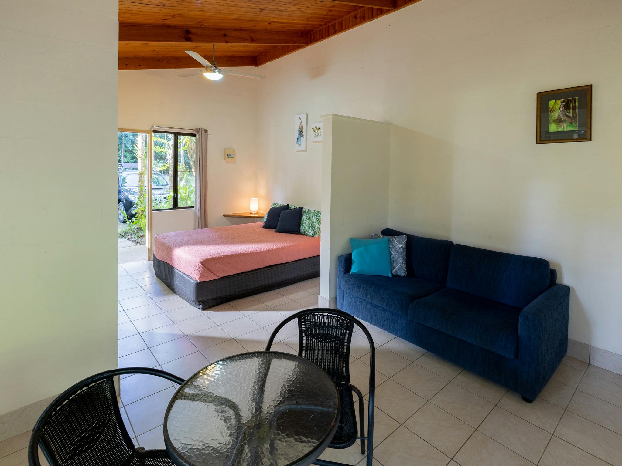 Queen motel room with bed, lounge and table set Queen motel room with bed, lounge and table set