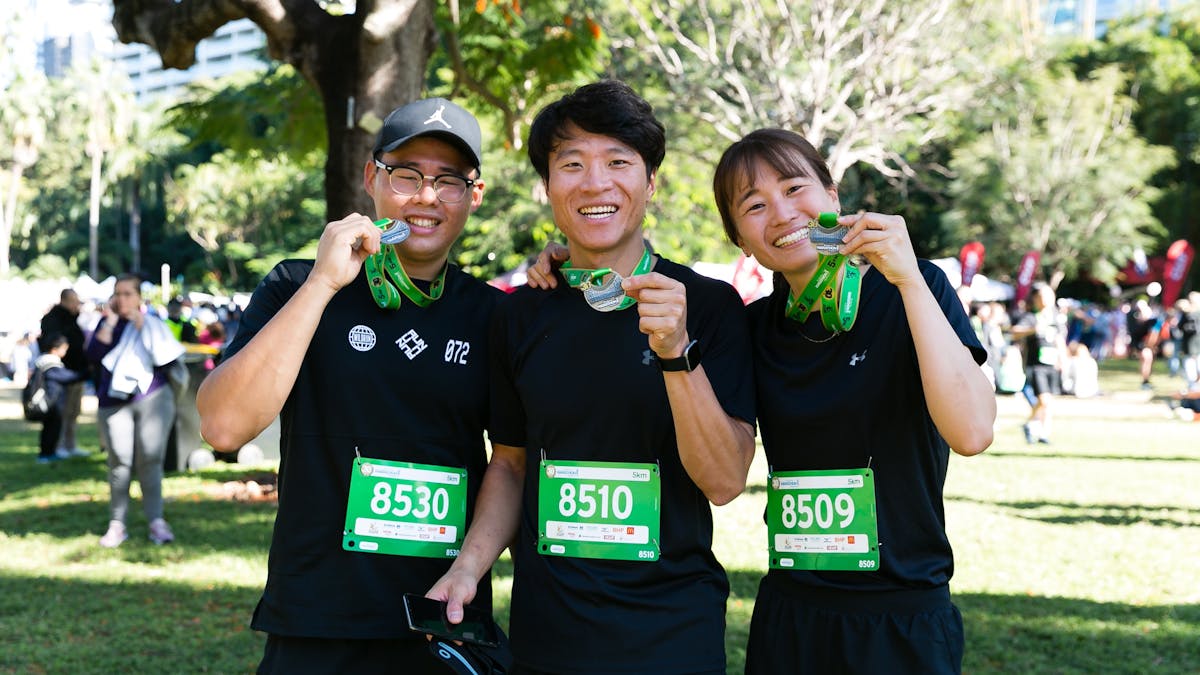 friends holding running medal