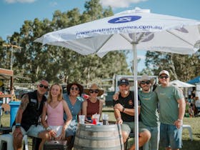 A group of family and friends catch up under the umbrella at Caltowie