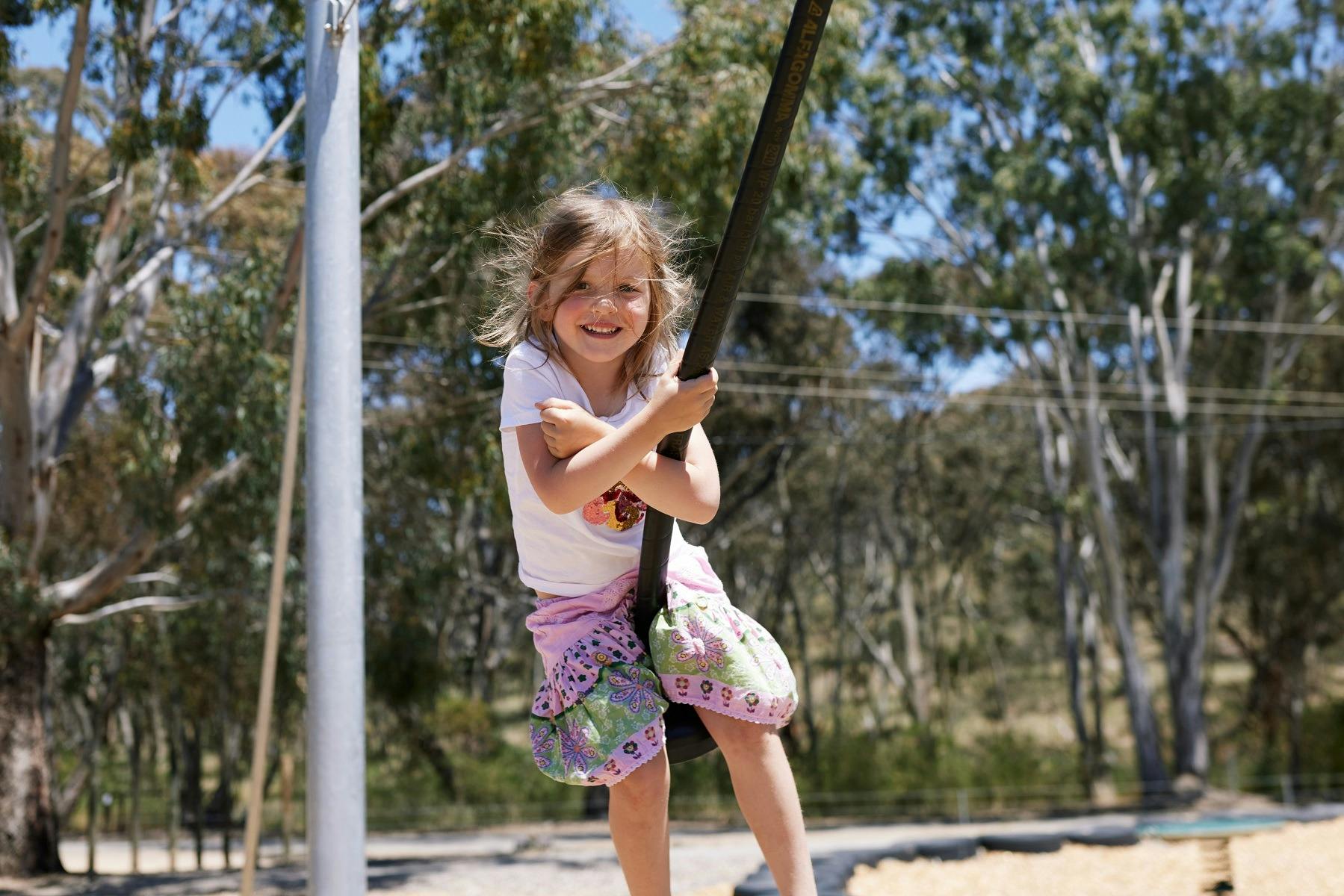 Child on flying fox, Richardson Park Playspace at Sevenhill