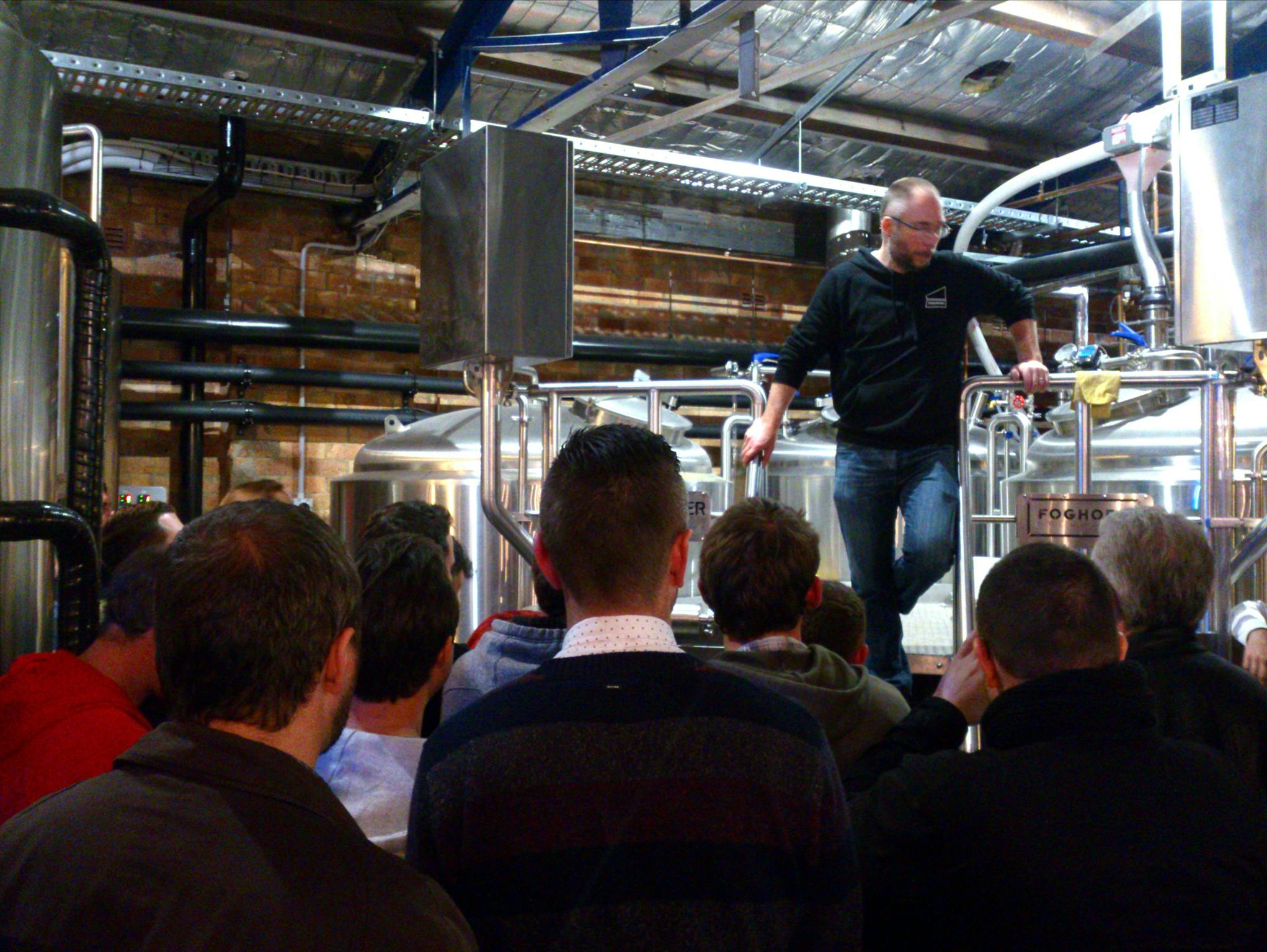 The head brewer of FogHorn standing on the brewing platform while he addresses the small crowd below