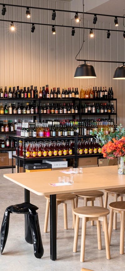 Store layout of Paranormal Wines - stools, tables and variety of wines