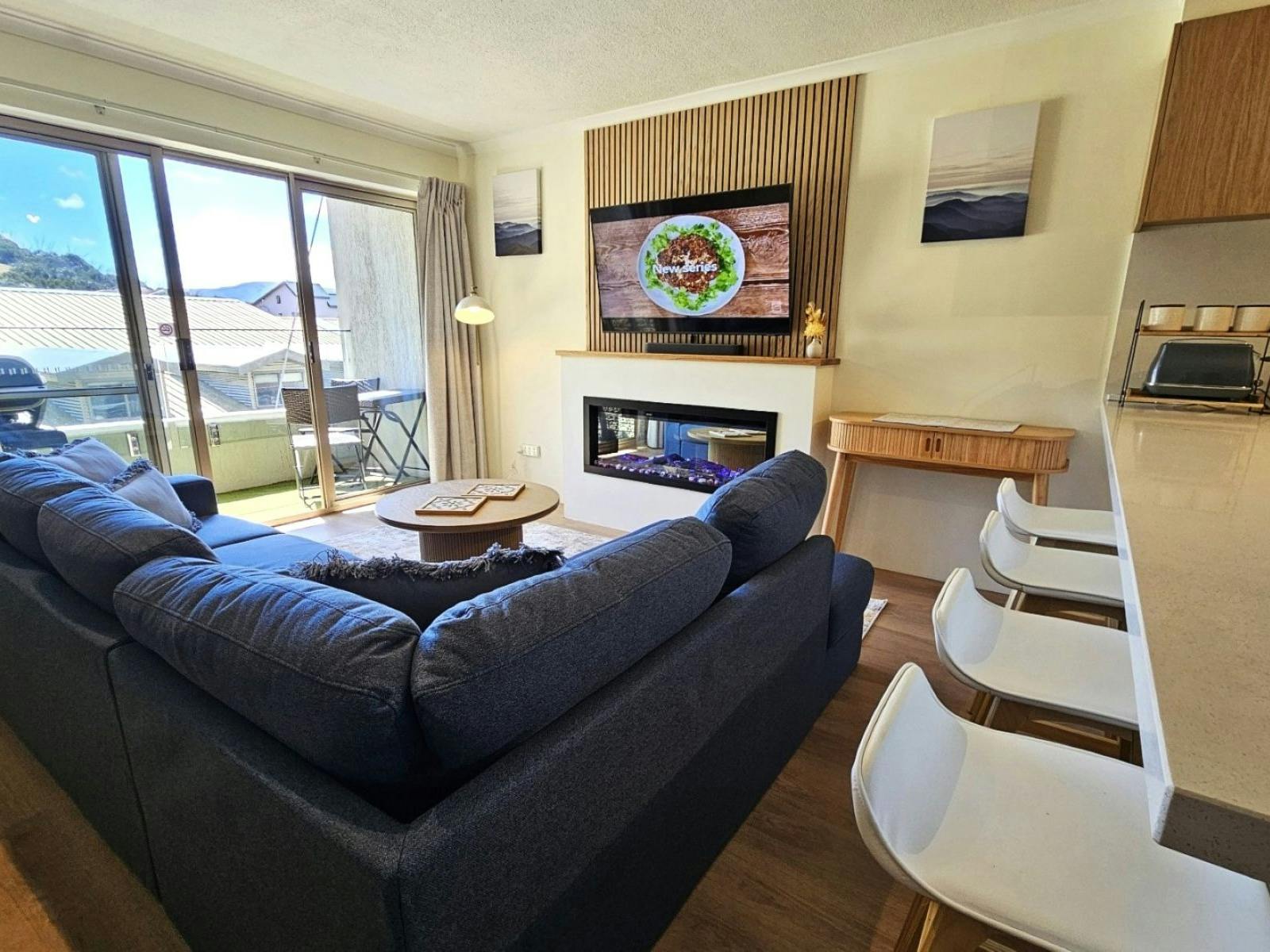 Living room with couch, tables, chairs and a fireplace