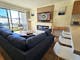 Living room with couch, tables, chairs and a fireplace