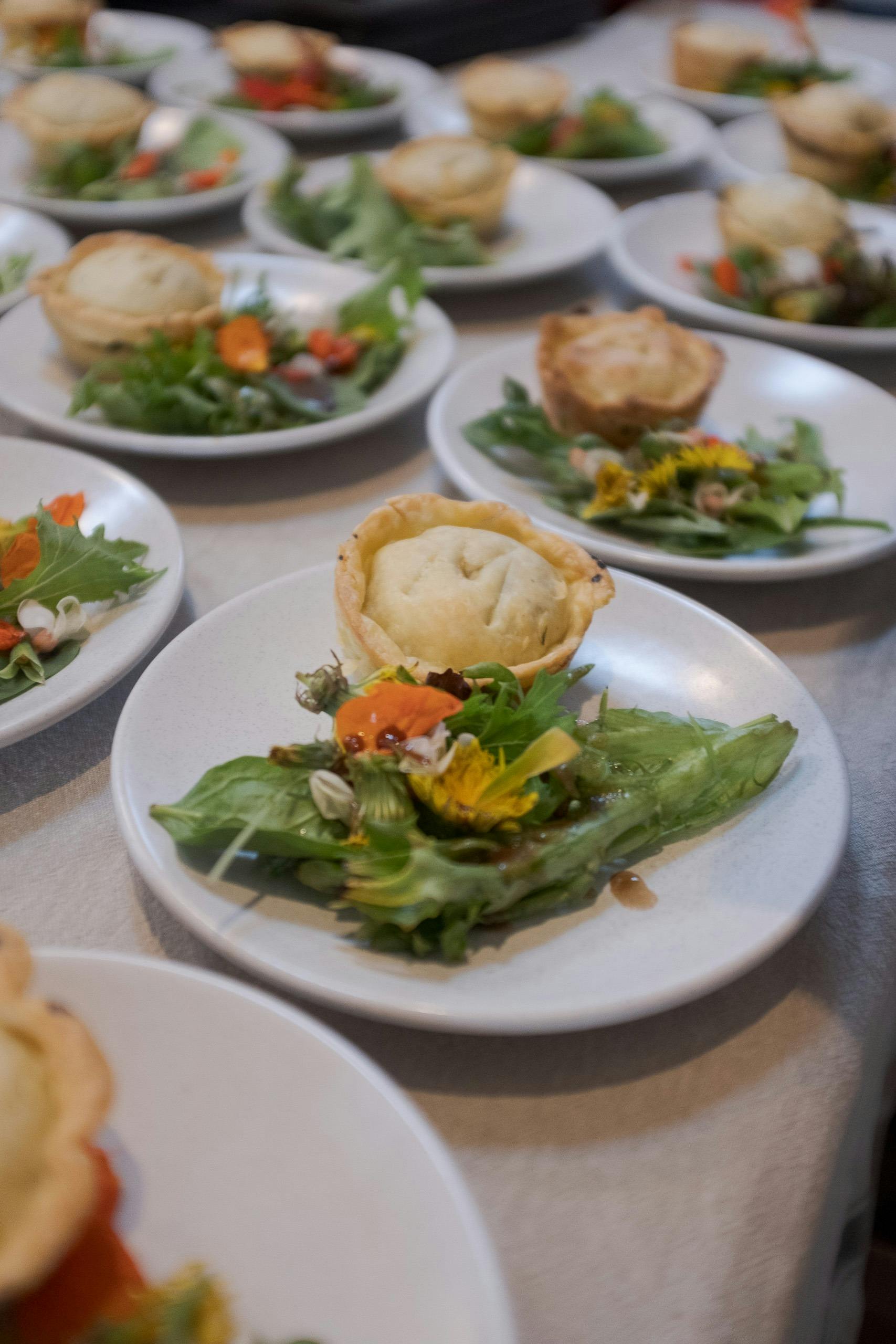 a longtable of yummy food prepared with foraged ingredients